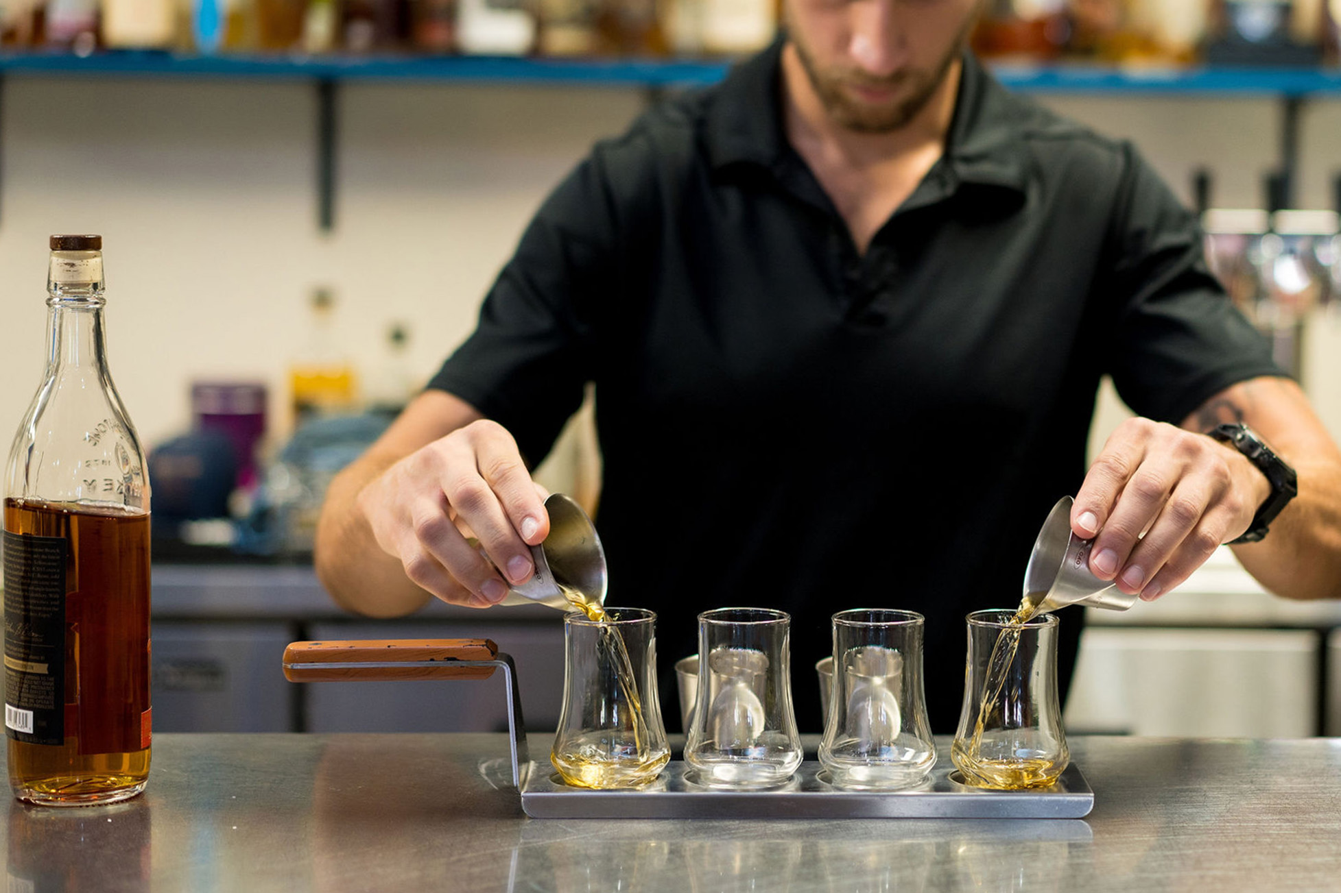 man pouring bourbon cocktails at brothers beer and bourbon